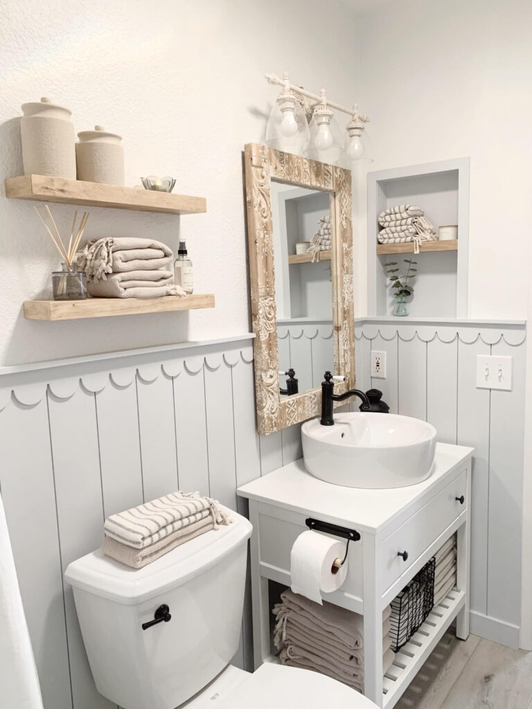 Bathroom with Sherwin Williams Pure White walls and Olympus White Scalloped Shiplap trim, black bathroom hardware and wood accents