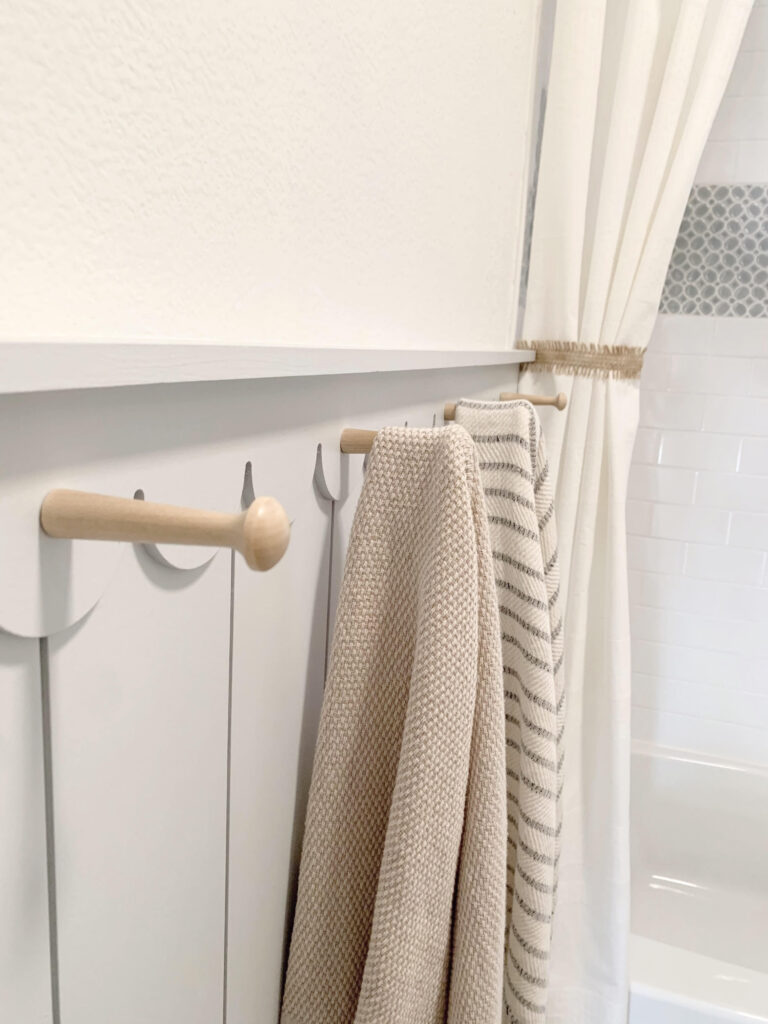 natural wood pegs used in bathroom to hang Olive & Linen towels