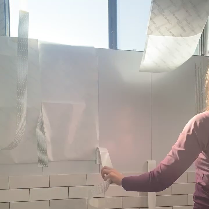 applying Musselbound tile mat and Musselbound waterproofing seam tape to wall