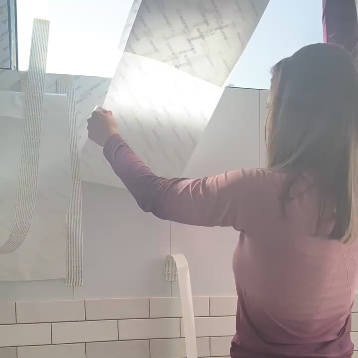 applying Musselbound tile mat and Musselbound waterproofing seam tape to wall