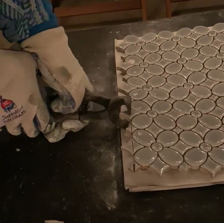 Cutting small porcelain mosaic tile with tile nippers