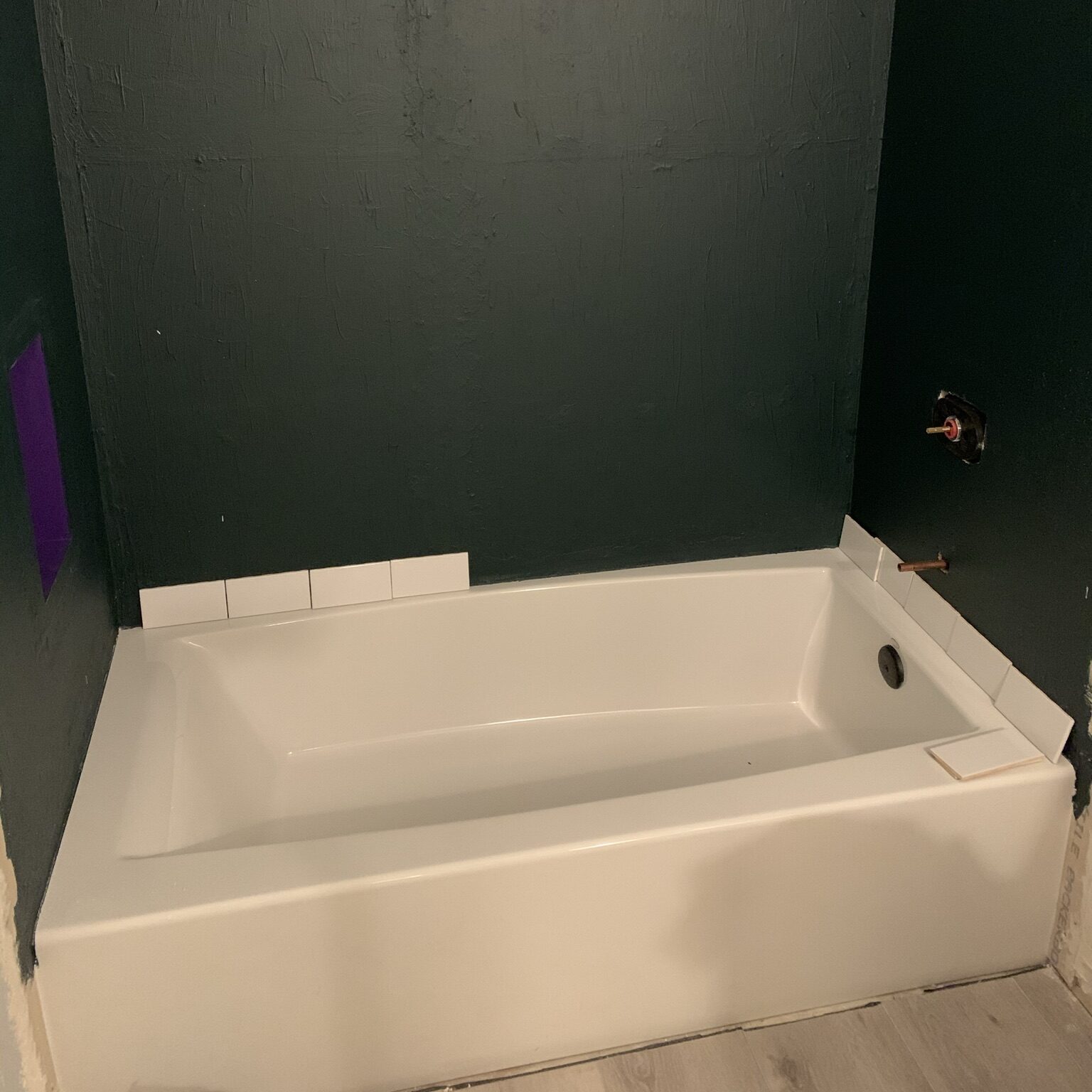Mapei AquaDefense on shower wall with bathtub