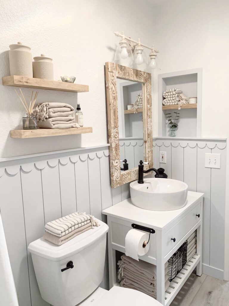 Beachy bathroom with vertical shiplap, scalloped trim and wood accents