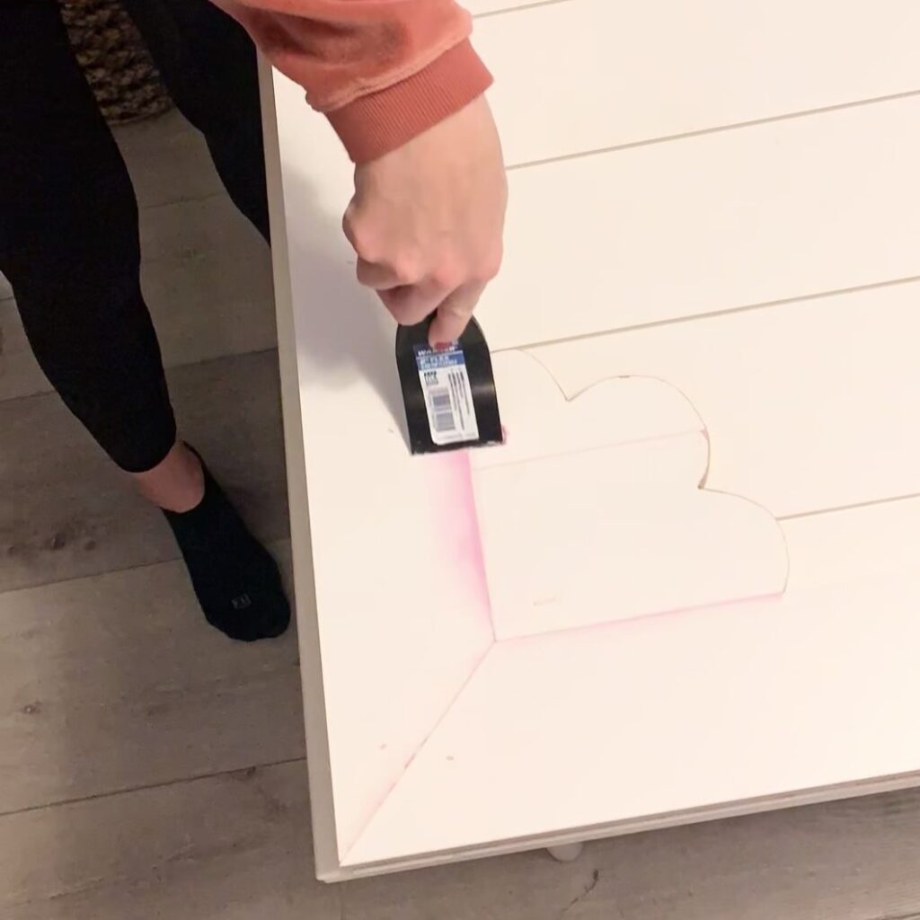 applying spackle to barn door