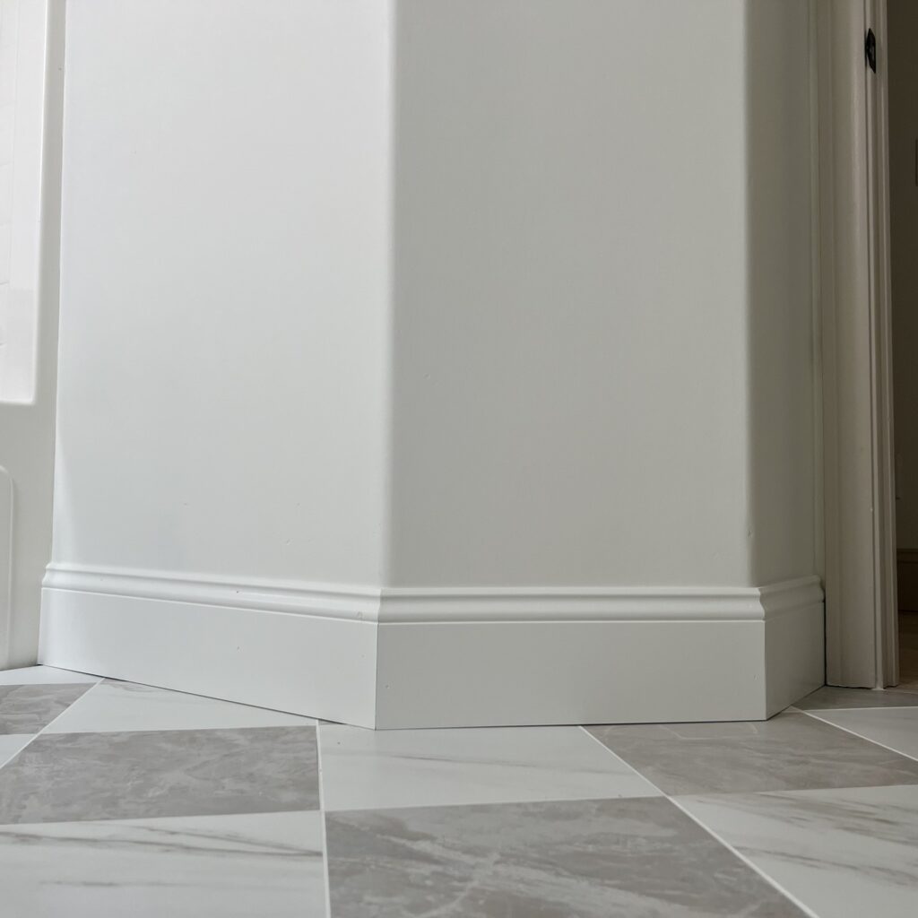 checkered tile floors with white baseboards