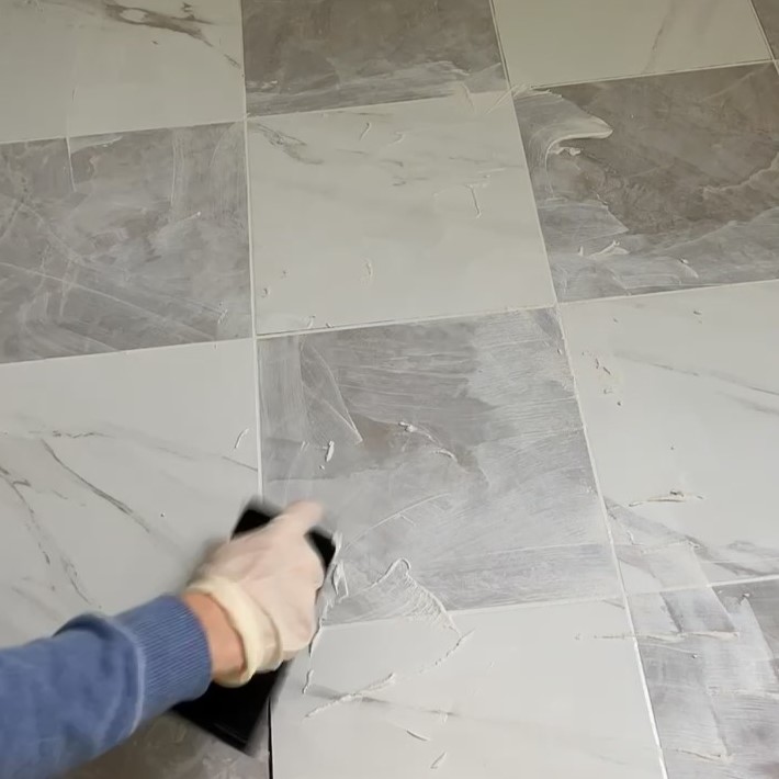 grouting gray and white tile floor