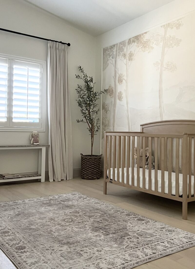 Gender neutral nursery with wallpaper mural