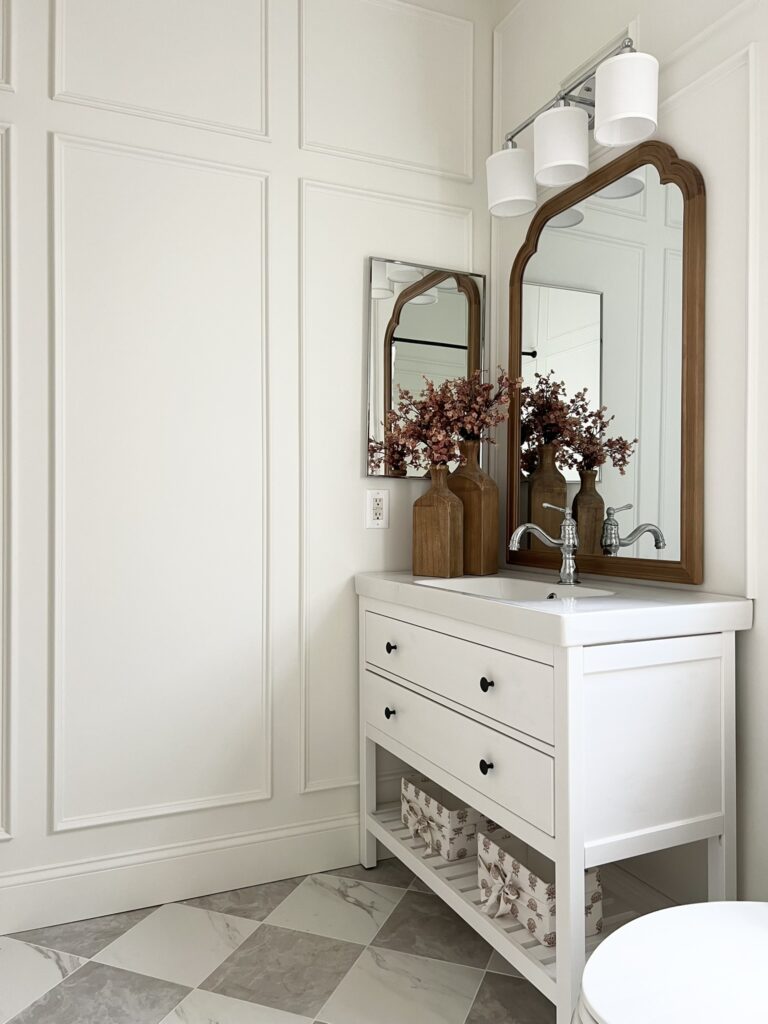 checkered floor with wall trim and wood mirror