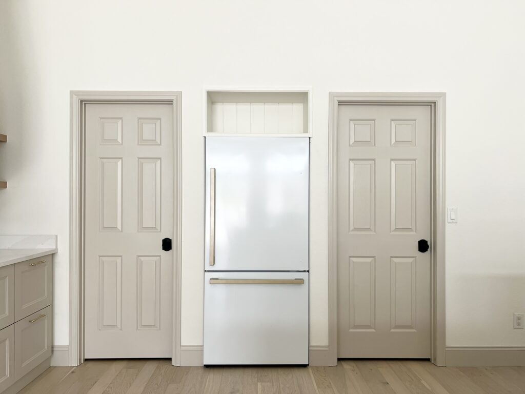 kitchen with Accessible Beige doors and custom cabinet above fridge
