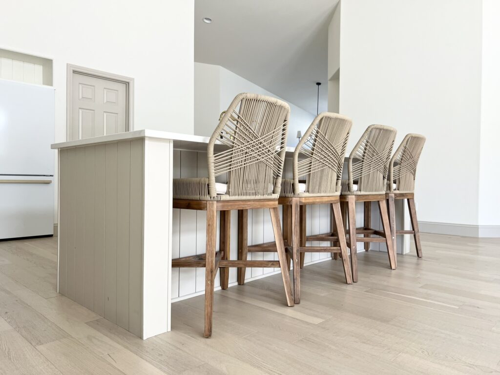 large kitchen island overhang with four LILLIAN AUGUST Rope Cross Weave Counter Stools