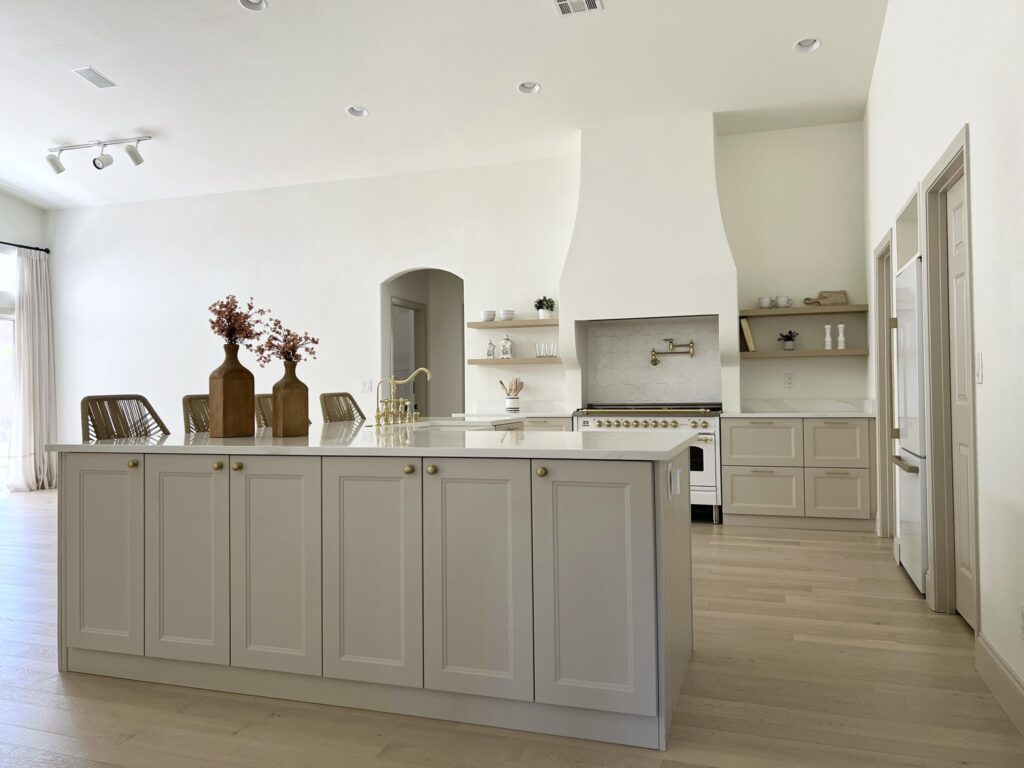 remodeled kitchen with IKEA cabinets and Silestone Calacatta Gold quartz countertops and Hallman range along with custom range hood