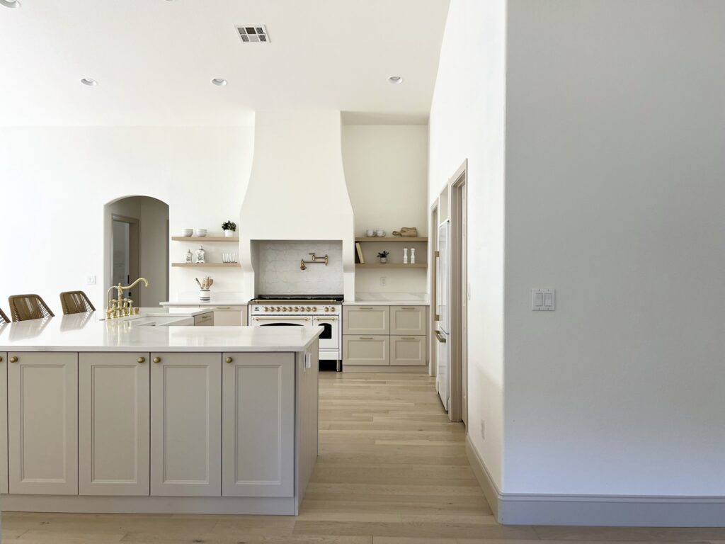 kitchen with Accessible Beige cabinets and white oak floors and white Hallman range