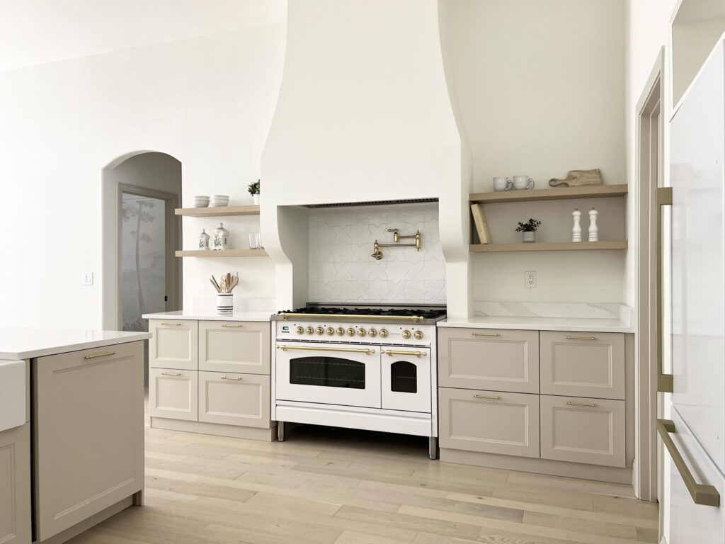white Hallman range with custom range hood and Accessible Beige kitchen cabinets
