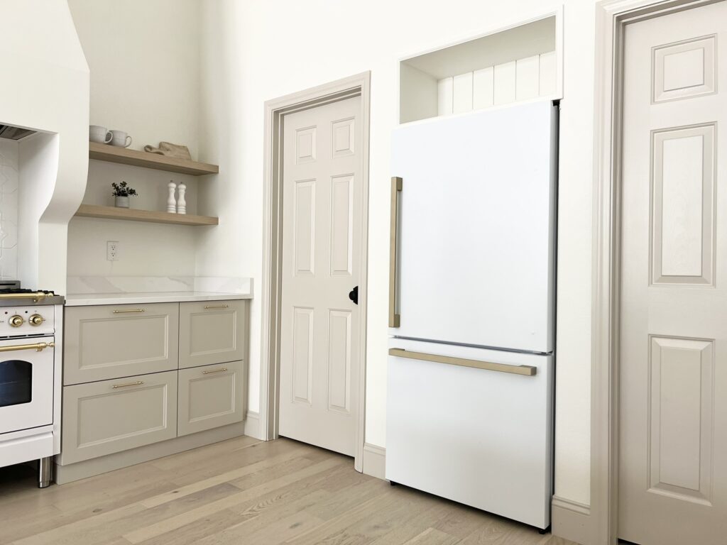 kitchen with Accessible Beige doors and custom cabinet above fridge