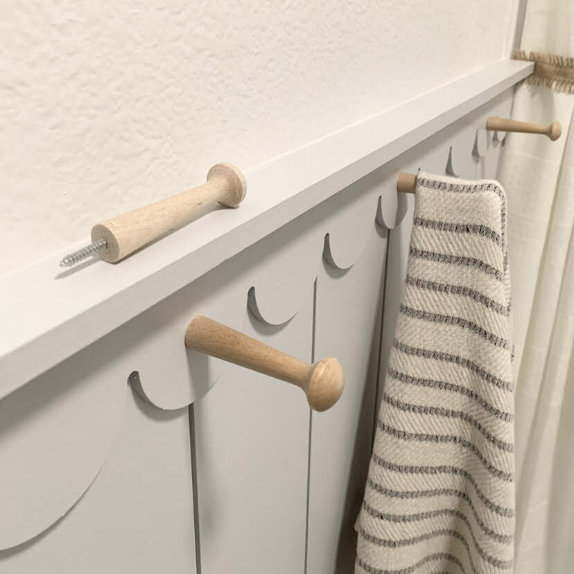 wood pegs with screws used in bathroom to hang towels