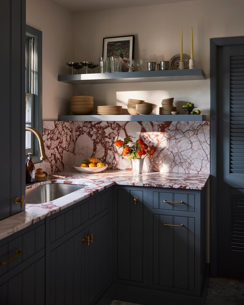 blue kitchen cabinets with red and white countertop