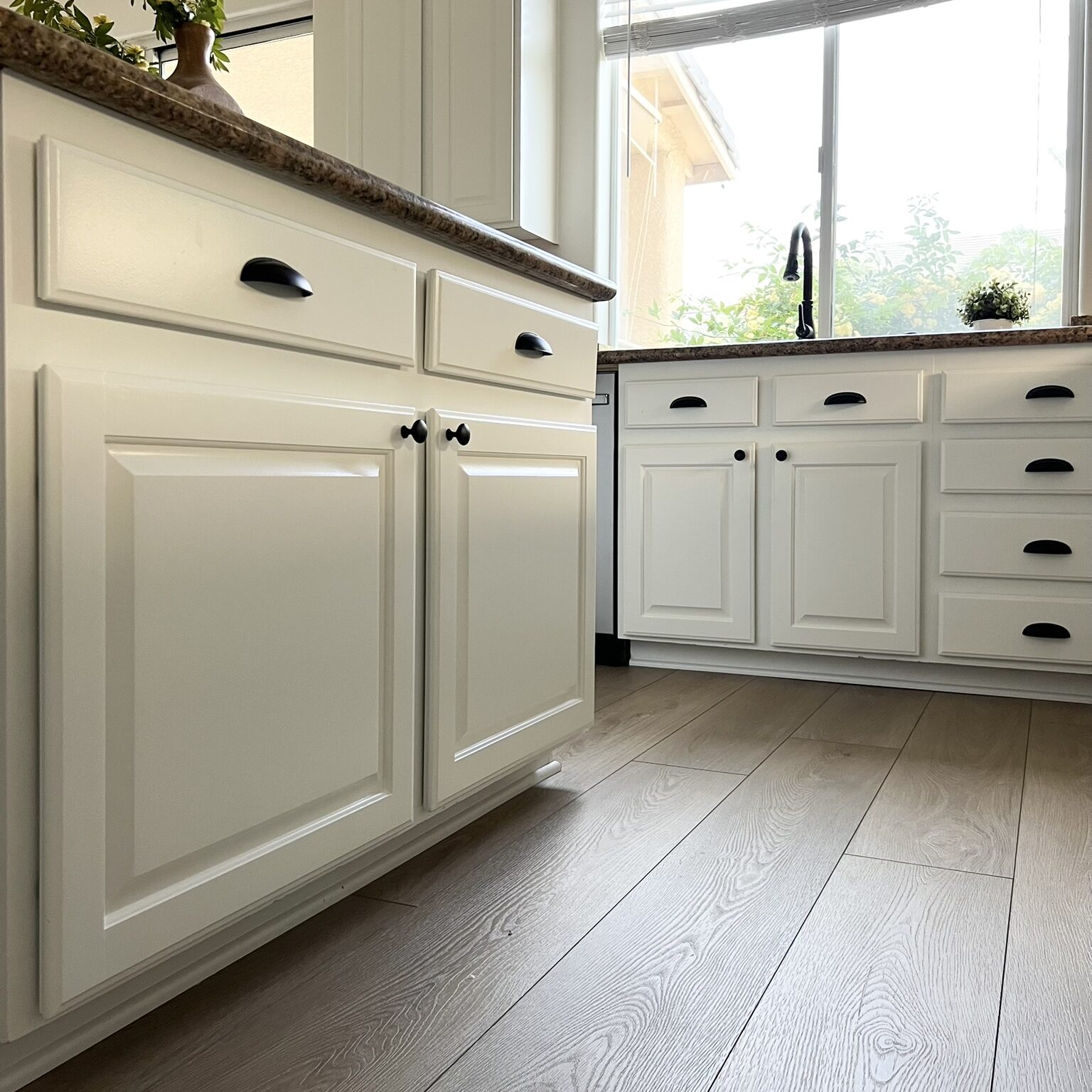 Alabaster kitchen cabinets with black cabinet hardware