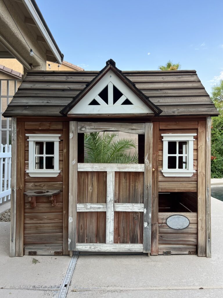 old wood playhouse before makeover