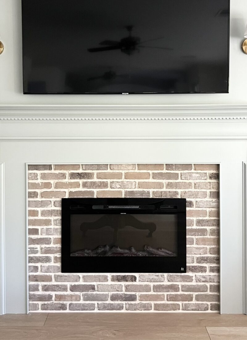 DIY electric fireplace with brick veneer and traditional fireplace mantel