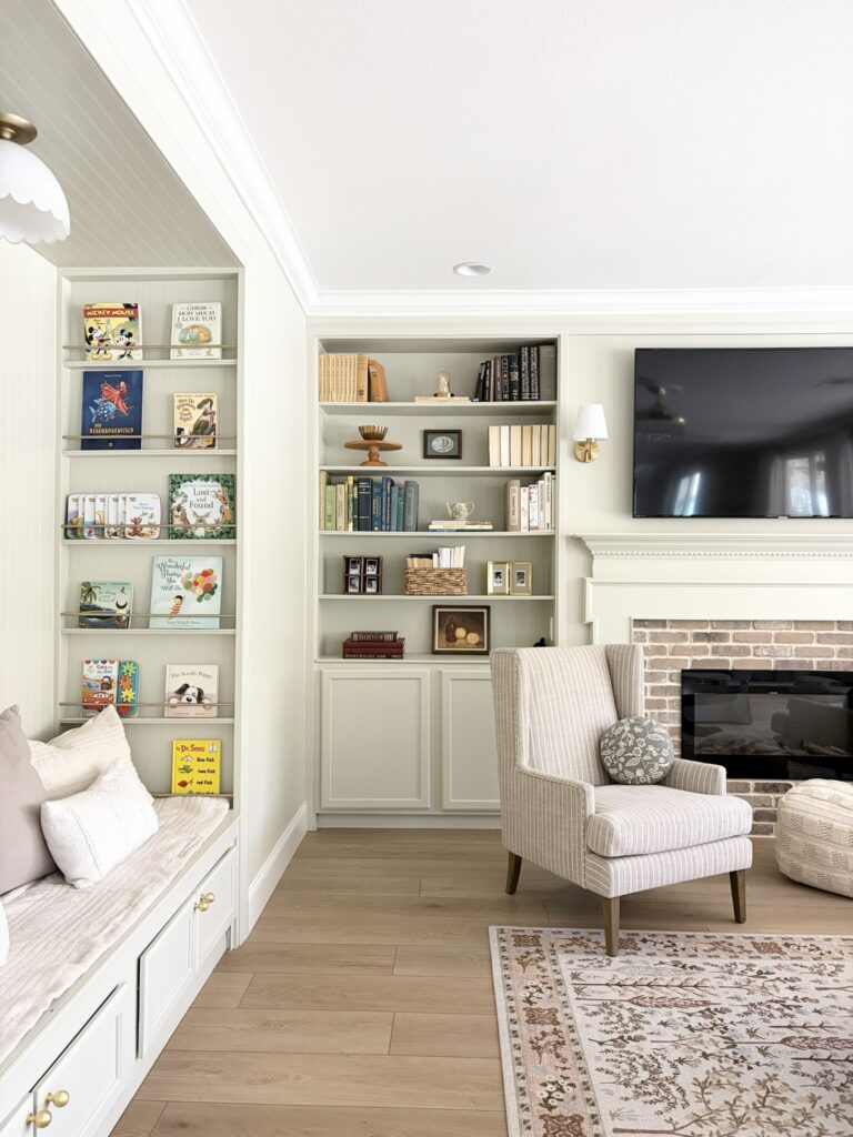 living room with fireplace built ins and kids reading nook