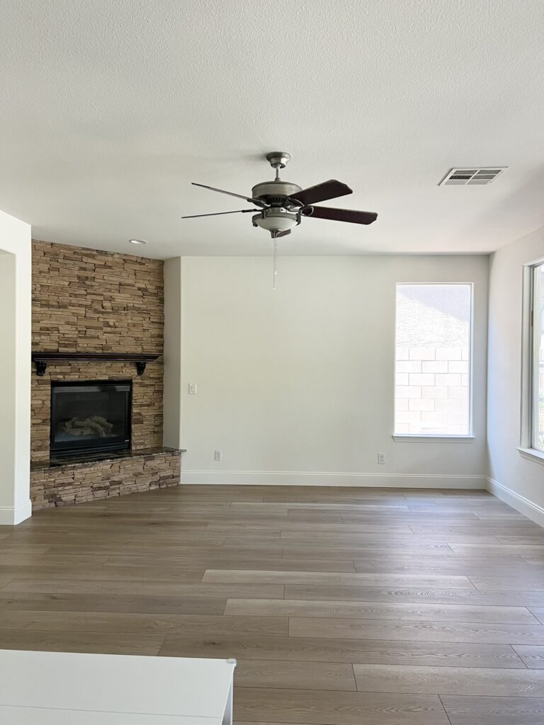 living room with fireplace in the corner
