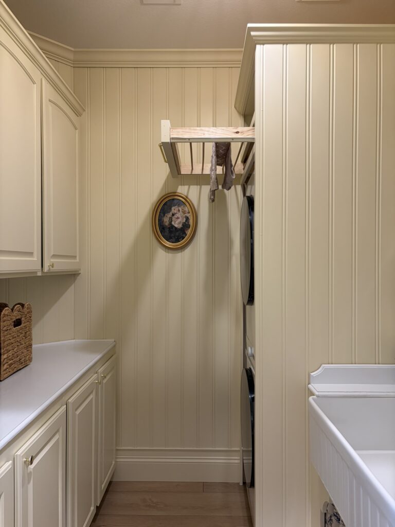 diy drying rack pull out drawer in a butter yellow laundry room with beadboard